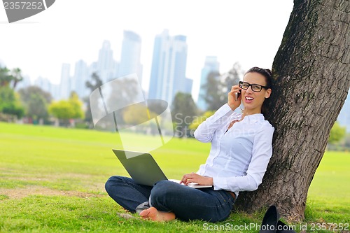 Image of woman with laptop in park