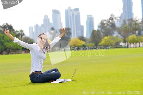 Image of woman with laptop in park