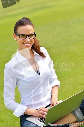 Image of woman with laptop in park