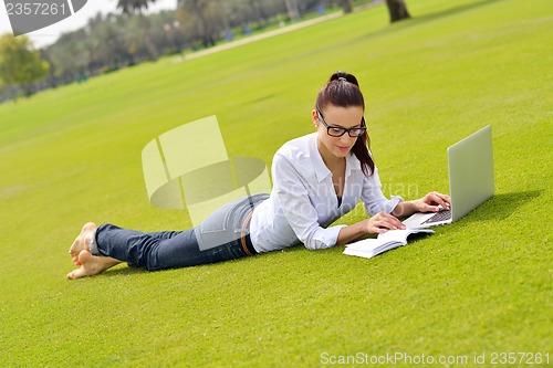 Image of woman with laptop in park