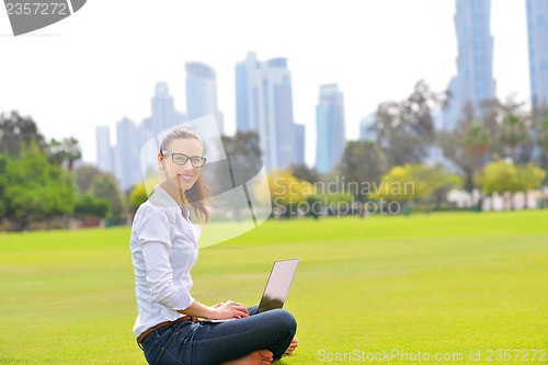 Image of woman with laptop in park