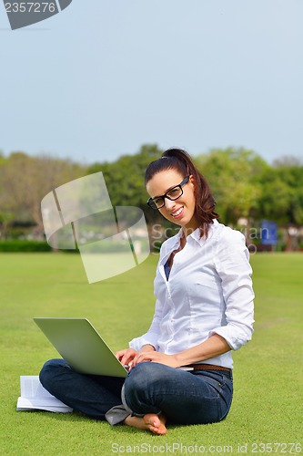 Image of woman with laptop in park