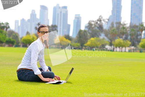 Image of woman with laptop in park