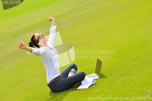 Image of woman with laptop in park