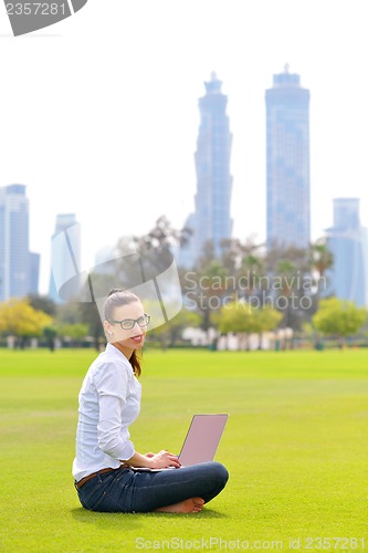 Image of woman with laptop in park