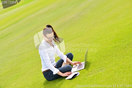 Image of woman with laptop in park