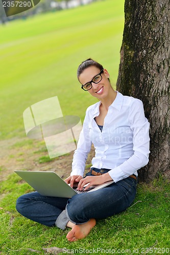 Image of woman with laptop in park