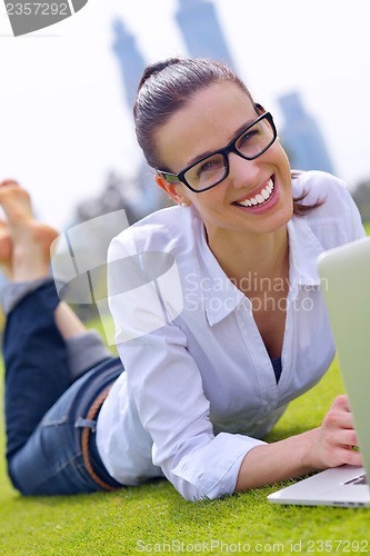 Image of woman with laptop in park