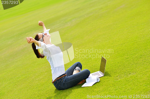 Image of woman with laptop in park