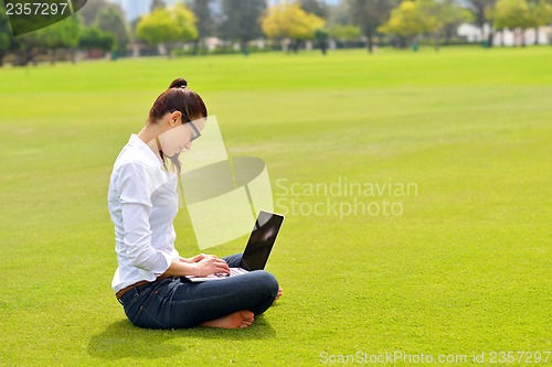 Image of woman with laptop in park
