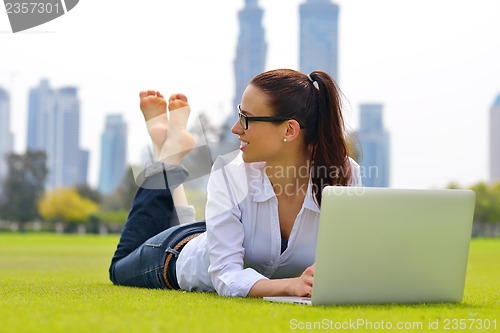 Image of woman with laptop in park