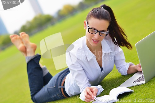 Image of woman with laptop in park