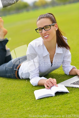 Image of woman with laptop in park