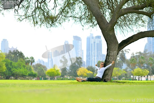 Image of woman with laptop in park