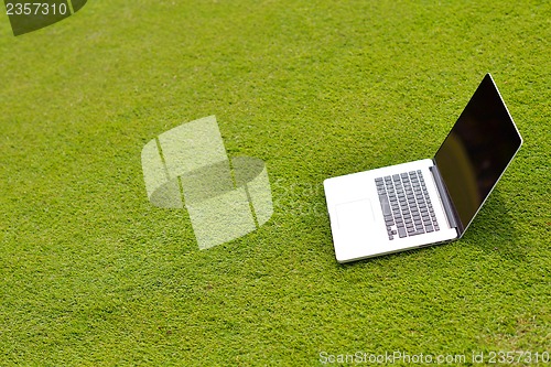 Image of laptop computer  on grass