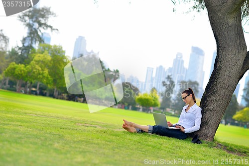 Image of woman with laptop in park