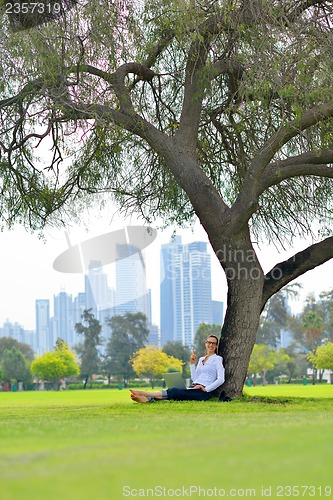 Image of woman with laptop in park