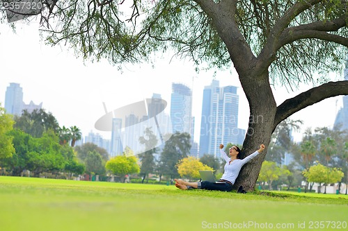 Image of woman with laptop in park