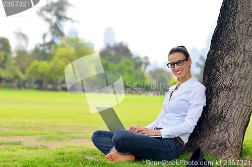 Image of woman with laptop in park