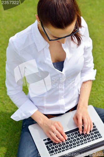 Image of woman with laptop in park