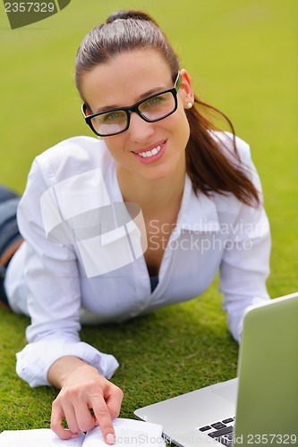 Image of woman with laptop in park