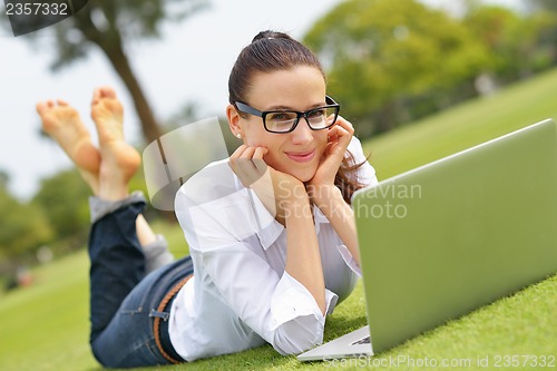 Image of woman with laptop in park