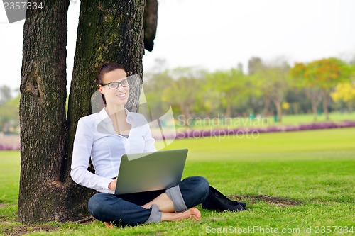 Image of woman with laptop in park