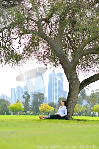 Image of woman with laptop in park