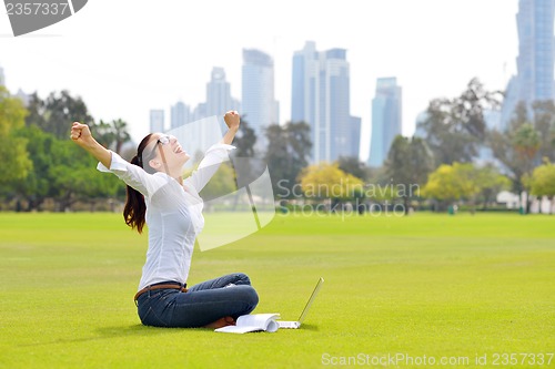 Image of woman with laptop in park