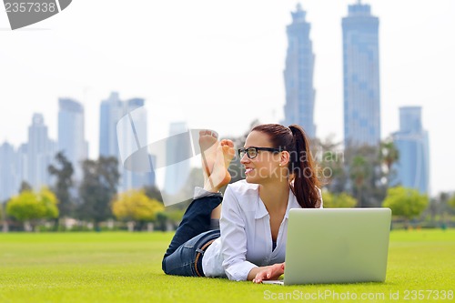 Image of woman with laptop in park