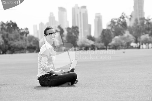 Image of woman with laptop in park
