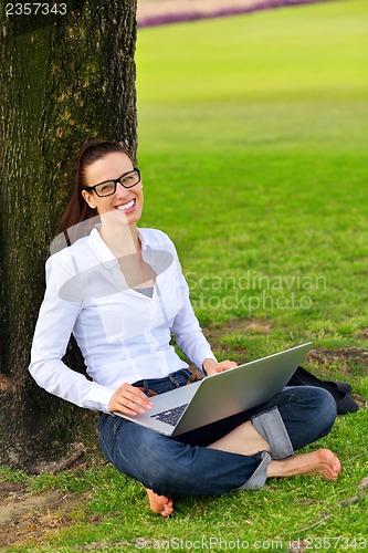 Image of woman with laptop in park
