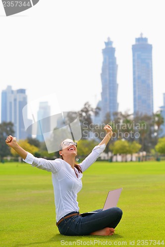 Image of woman with laptop in park