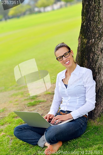 Image of woman with laptop in park