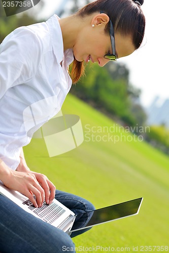 Image of woman with laptop in park
