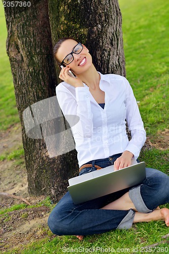 Image of woman with laptop in park