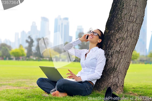 Image of woman with laptop in park