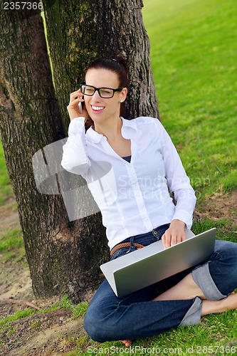 Image of woman with laptop in park