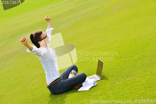 Image of woman with laptop in park