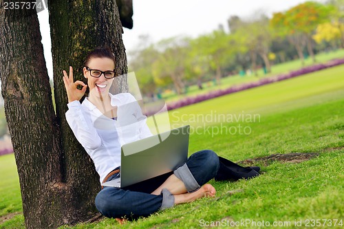 Image of woman with laptop in park