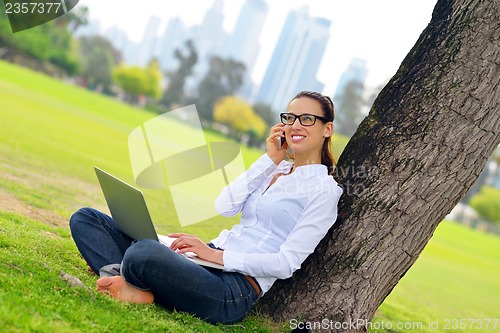 Image of woman with laptop in park