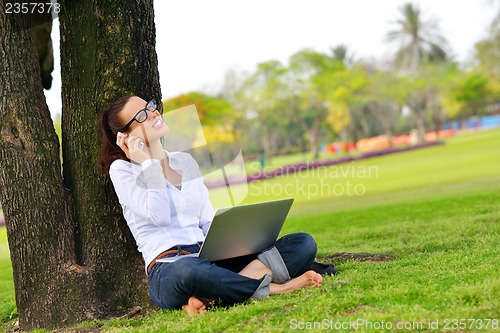 Image of woman with laptop in park