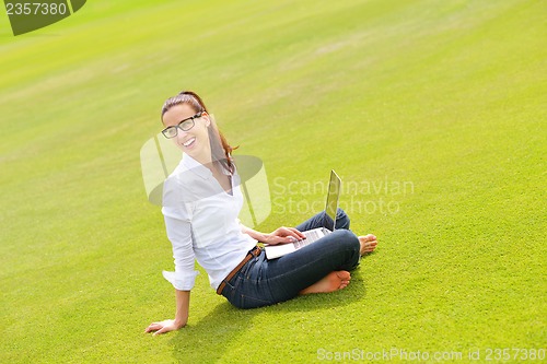Image of woman with laptop in park