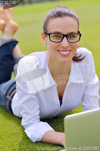 Image of woman with laptop in park