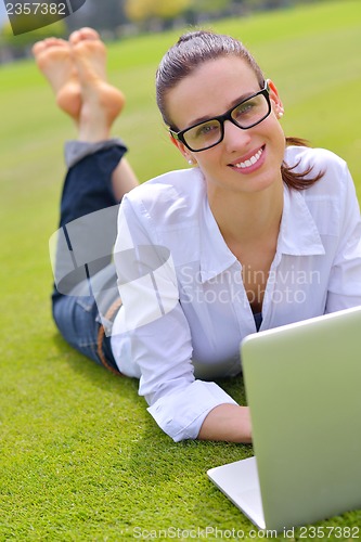 Image of woman with laptop in park