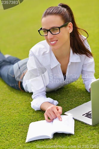 Image of woman with laptop in park