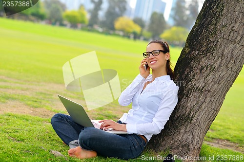 Image of woman with laptop in park