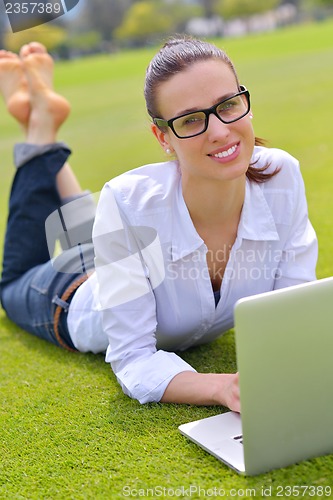 Image of woman with laptop in park