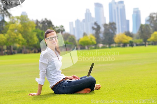 Image of woman with laptop in park