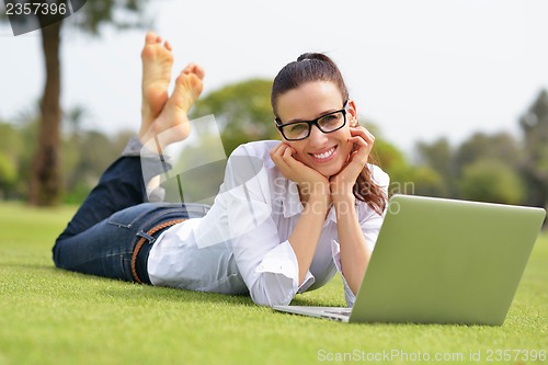 Image of woman with laptop in park